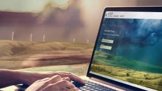 3 Tier website on a laptop with a wind farm in the background
