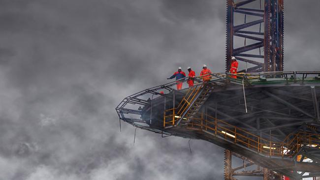 Workers on an elevated deck of a boat