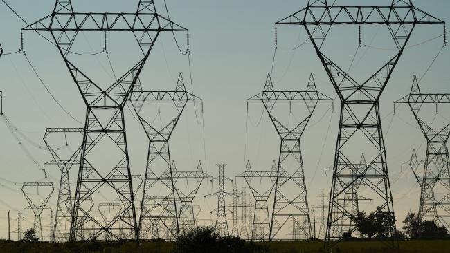 Power Grid Towers and Power Lines against a dusk sky