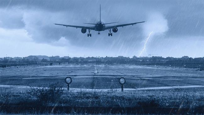Airplane landing to in a stormy weather to a runway at the airport